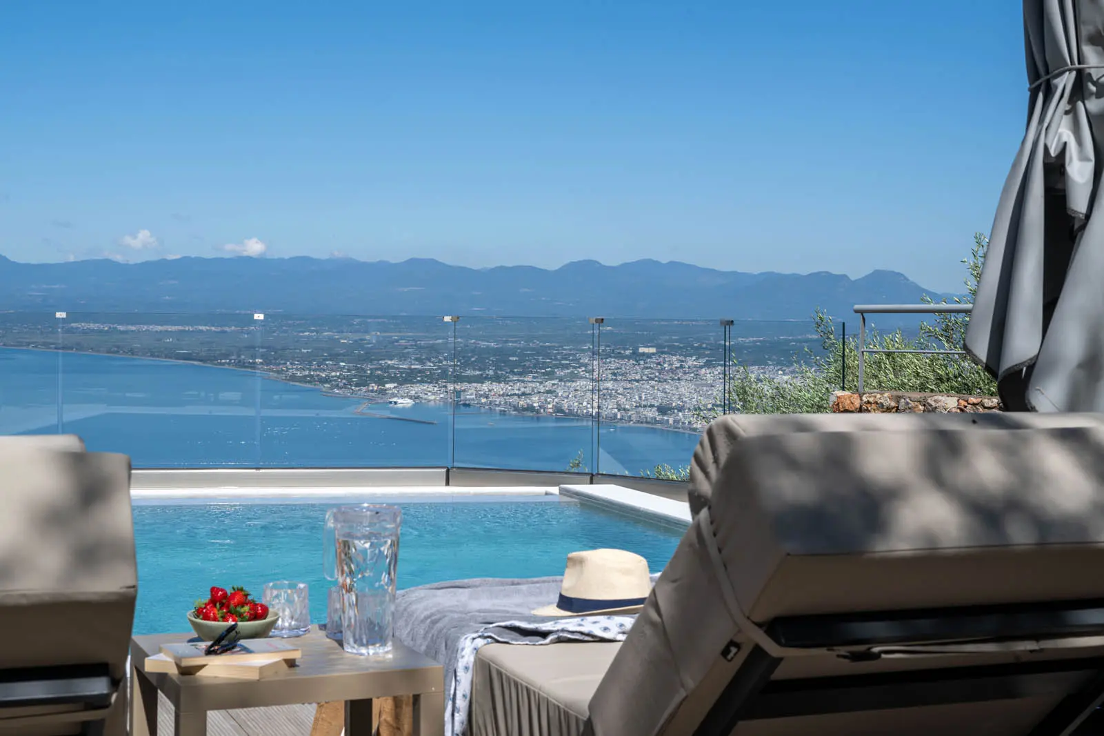 Private pool terrace in the morning light overlooking the Messinian Bay